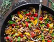 bowl of fresh vegetables with olive oil on a table