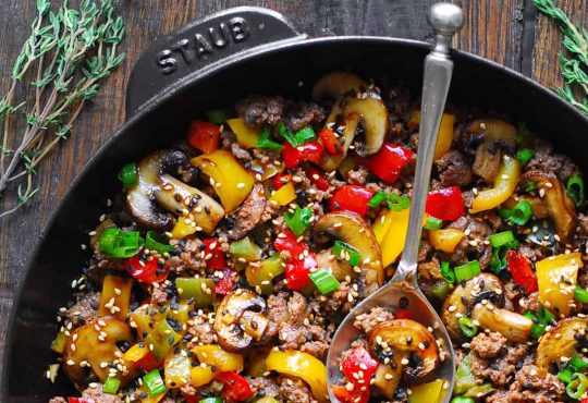 bowl of fresh vegetables with olive oil on a table
