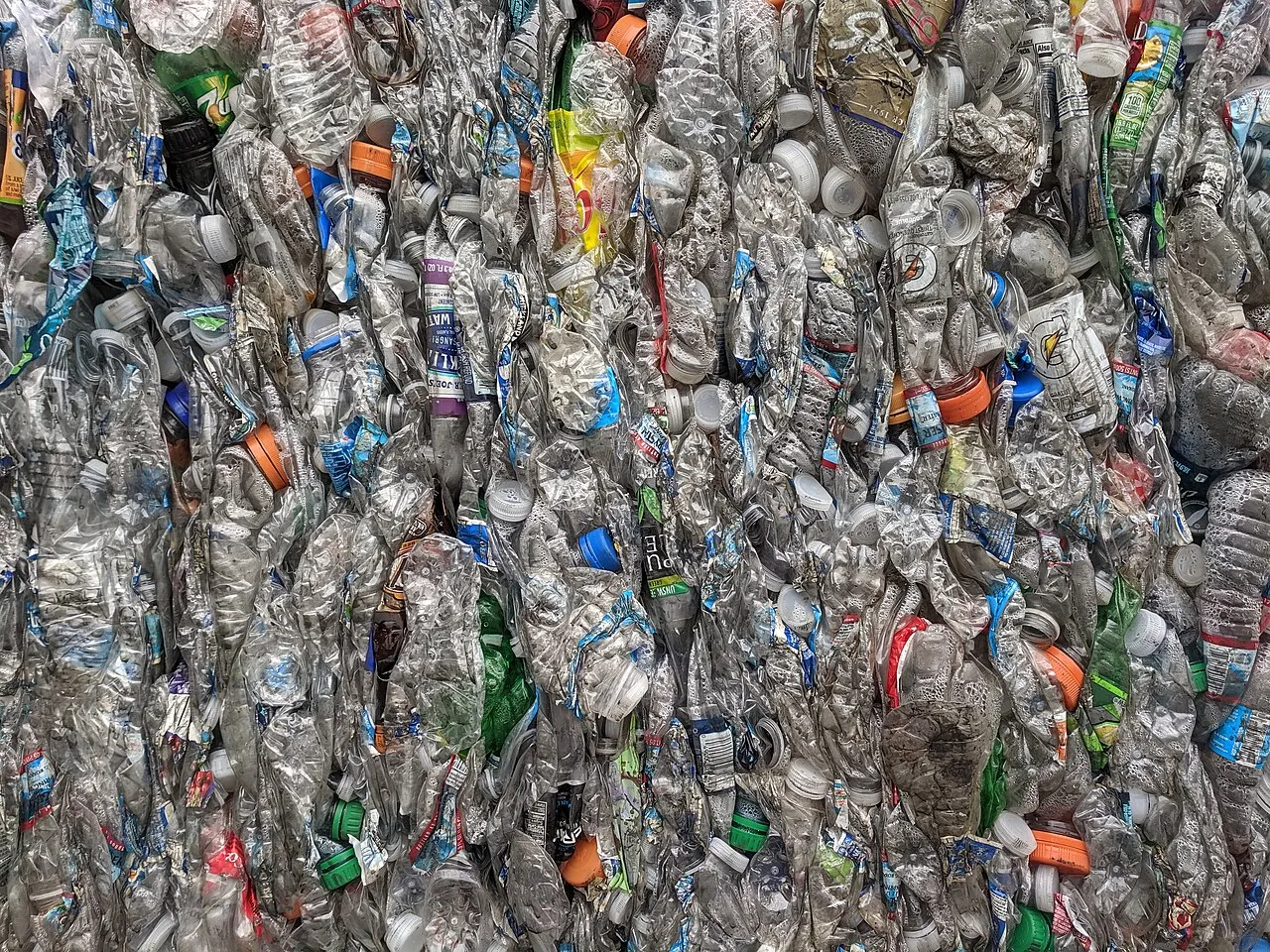 Compressed bales of used PET plastic bottles at a recycling facility