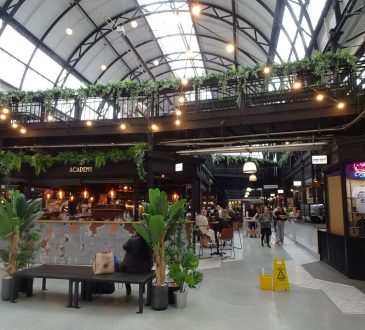 traders and shoppers in market hall