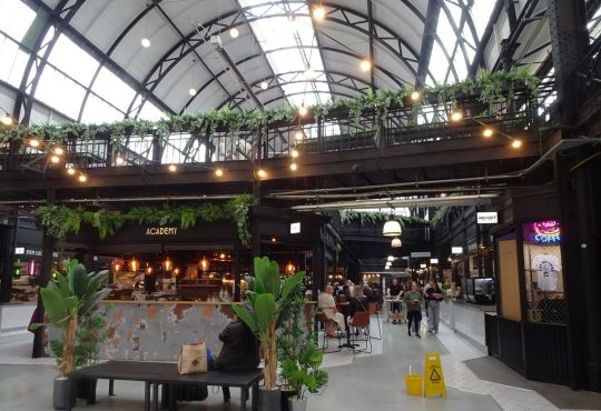 traders and shoppers in market hall