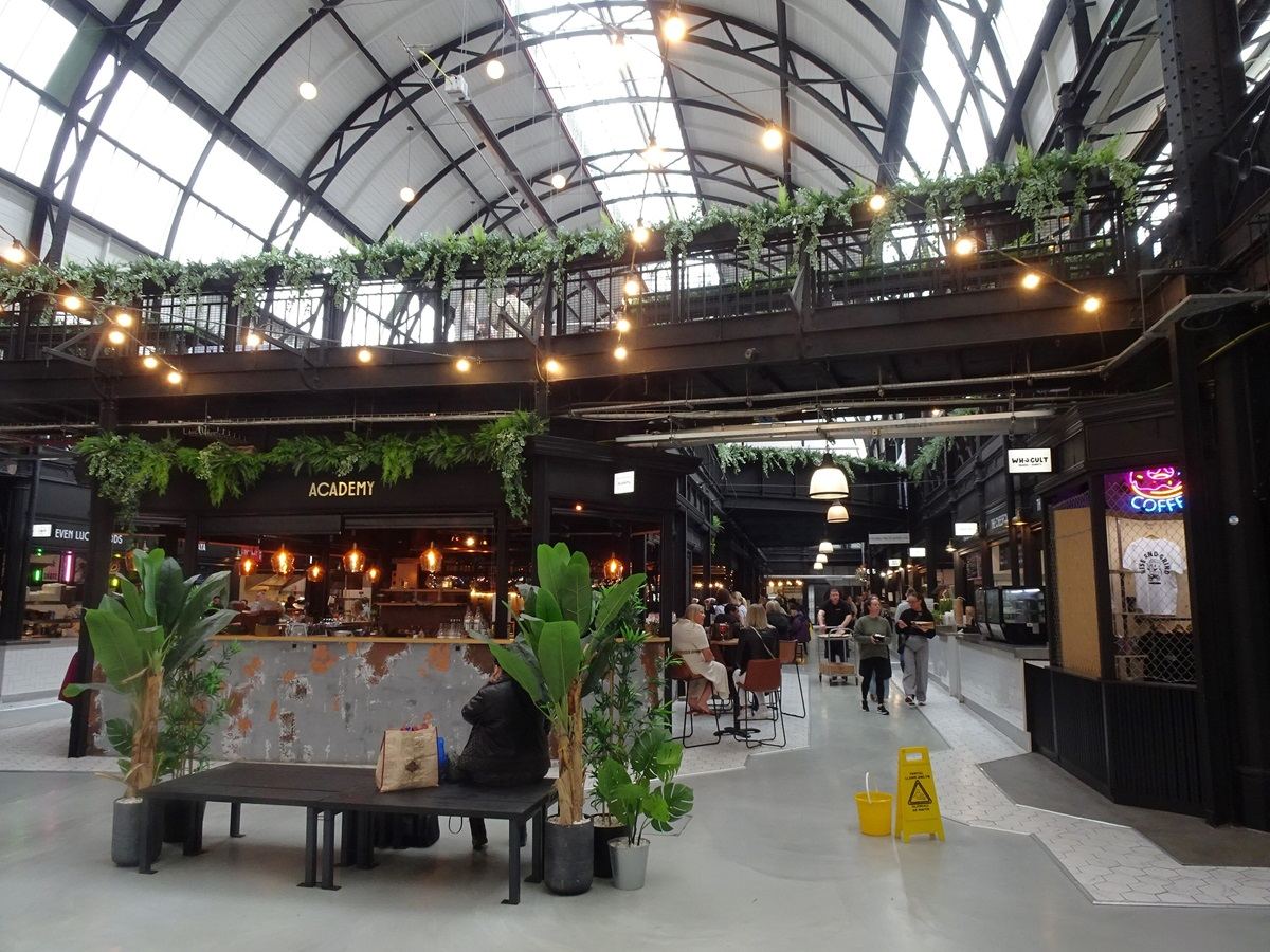 traders and shoppers in market hall